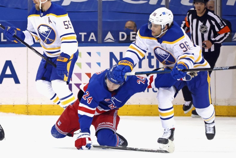 Apr 27, 2021; New York, NY, USA;  Anders Bjork #96 of the Buffalo Sabres checks Kaapo Kakko #24 of the New York Rangers during the first period at Madison Square Garden on April 27, 2021 in New York City.  Mandatory Credit: Bruce Bennett/Pool Photo-USA TODAY Sports