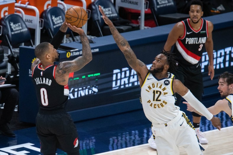 Apr 27, 2021; Indianapolis, Indiana, USA; Portland Trail Blazers guard Damian Lillard (0) shoots the ball over Indiana Pacers forward Oshae Brissett (12) during the second quarter at Bankers Life Fieldhouse. Mandatory Credit: Trevor Ruszkowski-USA TODAY Sports
