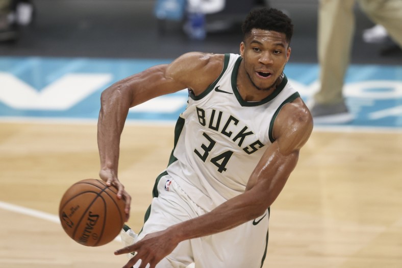 Apr 27, 2021; Charlotte, North Carolina, USA; Milwaukee Bucks forward Giannis Antetokounmpo (34) passes the basketball against the Charlotte Hornets during the second quarter at Spectrum Center. Mandatory Credit: Nell Redmond-USA TODAY Sports