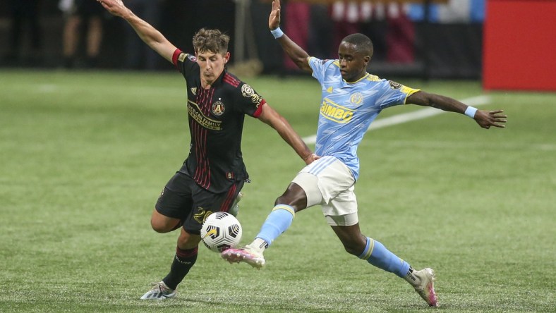 Apr 27, 2021; Atlanta, Georgia, USA; Atlanta United midfielder Emerson Hyndman (20) is defended by Philadelphia Union midfielder Jamiro Monteiro (10) in the first half at Mercedes-Benz Stadium. Mandatory Credit: Brett Davis-USA TODAY Sports