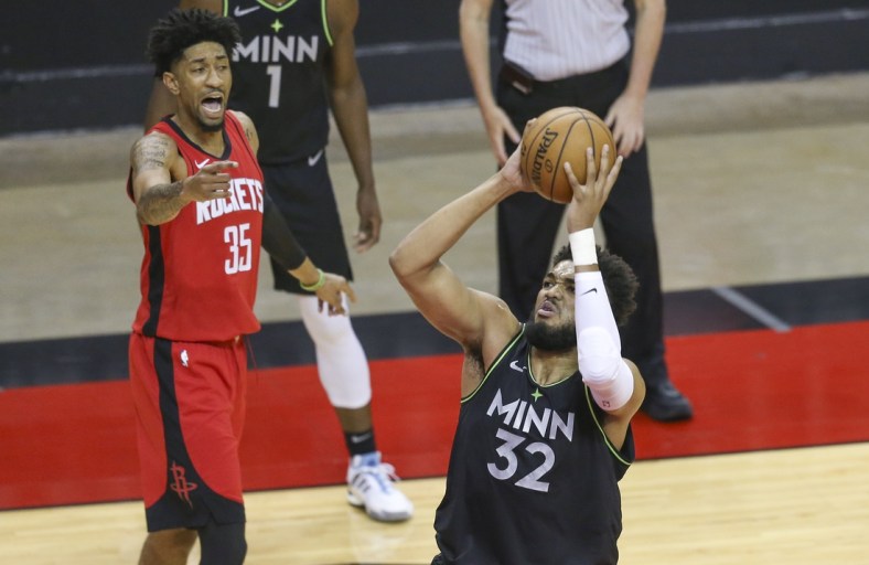 Apr 27, 2021; Houston, Texas, USA; Minnesota Timberwolves center Karl-Anthony Towns (32) shoots against Houston Rockets center Christian Wood (35) in the first quarter at Toyota Center. Mandatory Credit: Thomas Shea-USA TODAY Sports