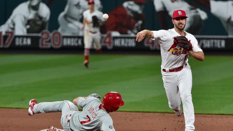 Apr 27, 2021; St. Louis, Missouri, USA;  St. Louis Cardinals shortstop Paul DeJong (11) turns a double play after forcing out Philadelphia Phillies pinch hitter Matt Joyce (7) during the eighth inning at Busch Stadium. Mandatory Credit: Jeff Curry-USA TODAY Sports