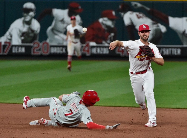 Apr 27, 2021; St. Louis, Missouri, USA;  St. Louis Cardinals shortstop Paul DeJong (11) turns a double play after forcing out Philadelphia Phillies pinch hitter Matt Joyce (7) during the eighth inning at Busch Stadium. Mandatory Credit: Jeff Curry-USA TODAY Sports