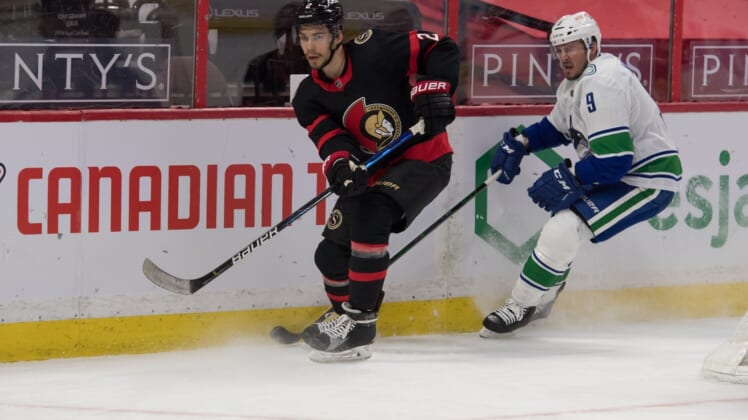 Apr 28, 2021; Ottawa, Ontario, CAN; Ottawa Senators defenseman Artem Zub (2) clears the puck away from Vancouver Canucks center J.T. Miller (9) in the first period at the Canadian Tire Centre. Mandatory Credit: Marc DesRosiers-USA TODAY Sports