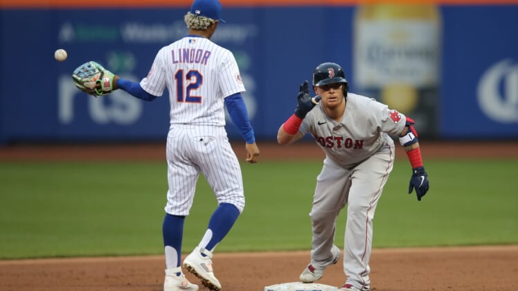 Apr 28, 2021; New York City, New York, USA; Boston Red Sox catcher  Christian Vazquez (7) reacts after his RBI double as New York Mets shortstop Francisco Lindor (12) takes the throw from the outfield during the second inning at Citi Field. Mandatory Credit: Brad Penner-USA TODAY Sports