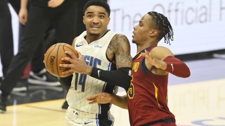Apr 28, 2021; Cleveland, Ohio, USA; Orlando Magic guard Gary Harris (14) drives against Cleveland Cavaliers forward Isaac Okoro (35) in the second quarter at Rocket Mortgage FieldHouse. Mandatory Credit: David Richard-USA TODAY Sports
