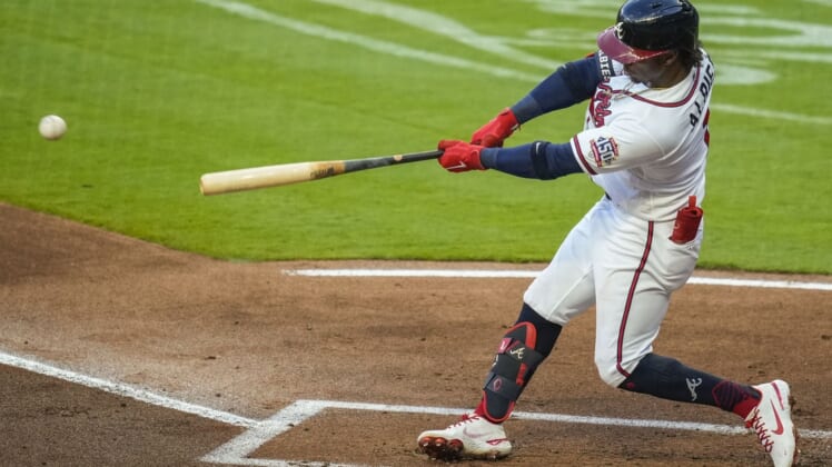 Apr 28, 2021; Cumberland, Georgia, USA; Atlanta Braves second baseman Ozzie Albies (1) hits a double against the Chicago Cubs during the first inning at Truist Park. Mandatory Credit: Dale Zanine-USA TODAY Sports