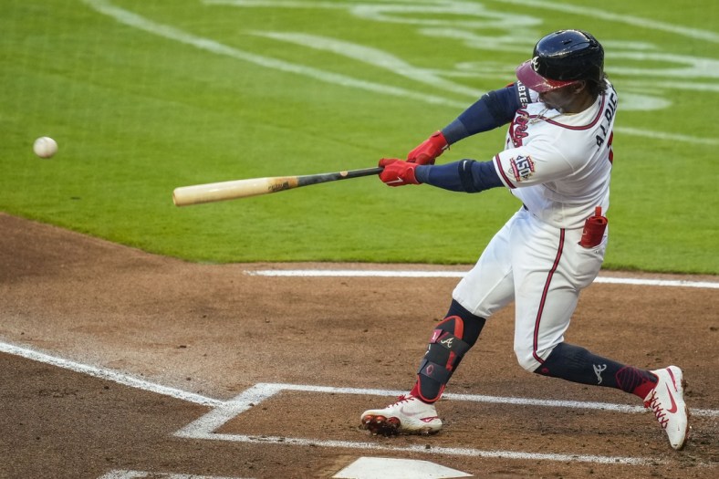 Apr 28, 2021; Cumberland, Georgia, USA; Atlanta Braves second baseman Ozzie Albies (1) hits a double against the Chicago Cubs during the first inning at Truist Park. Mandatory Credit: Dale Zanine-USA TODAY Sports