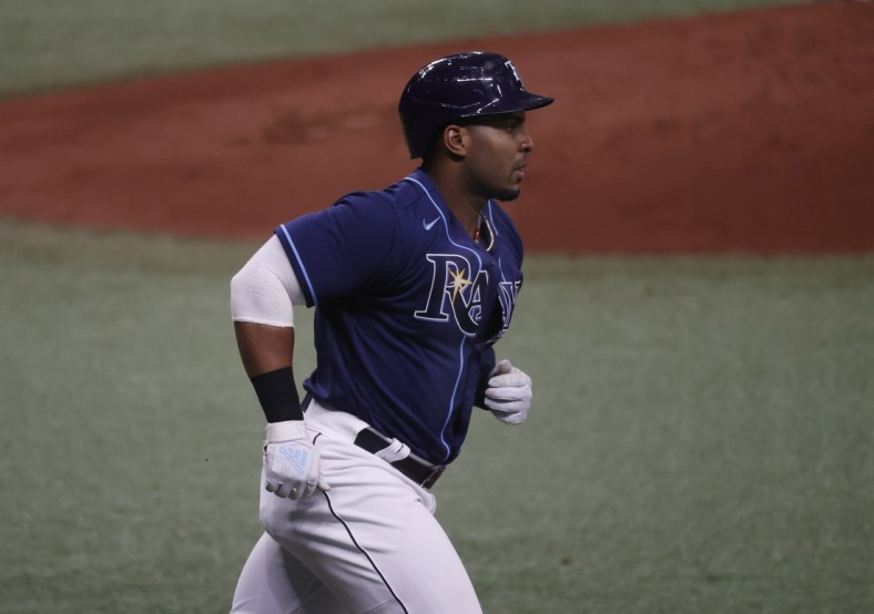Apr 28, 2021; St. Petersburg, Florida, USA; Tampa Bay Rays first baseman Yandy Diaz (2) singles during the second inning against the Oakland Athletics  at Tropicana Field. Mandatory Credit: Kim Klement-USA TODAY Sports