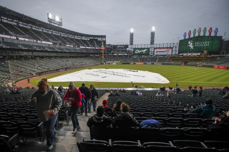 Apr 28, 2021; Chicago, Illinois, USA; Fans leave Guaranteed Rate Field after it was announced that the game between the Chicago White Sox and Detroit Tigers has been postponed due to inclement weather. Mandatory Credit: Kamil Krzaczynski-USA TODAY Sports
