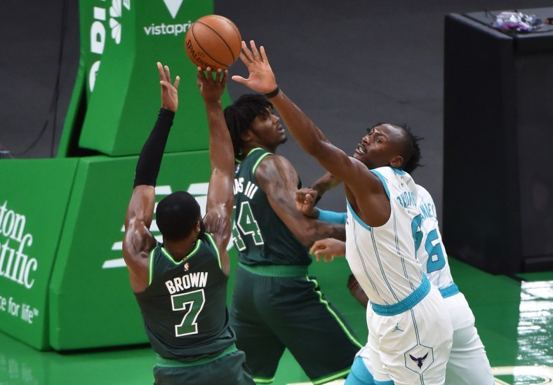 Apr 28, 2021; Boston, Massachusetts, USA;  Boston Celtics guard Jaylen Brown (7) shoots the ball over Charlotte Hornets center Bismack Biyombo (8) during the first half at TD Garden. Mandatory Credit: Bob DeChiara-USA TODAY Sports