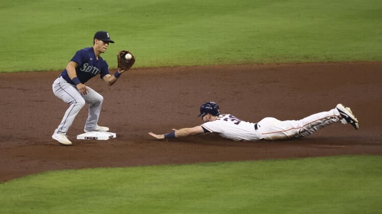Apr 28, 2021; Houston, Texas, USA; Houston Astros right fielder Kyle Tucker (30) slides safely into second base as Seattle Mariners second baseman Sam Haggerty (0) fields a throw during the second inning at Minute Maid Park. Mandatory Credit: Troy Taormina-USA TODAY Sports