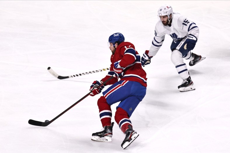Apr 28, 2021; Montreal, Quebec, CAN; Montreal Canadiens right wing Josh Anderson (17) plays the puck against Toronto Maple Leafs center Alexander Kerfoot (15) during the first period at Bell Centre. Mandatory Credit: Jean-Yves Ahern-USA TODAY Sports