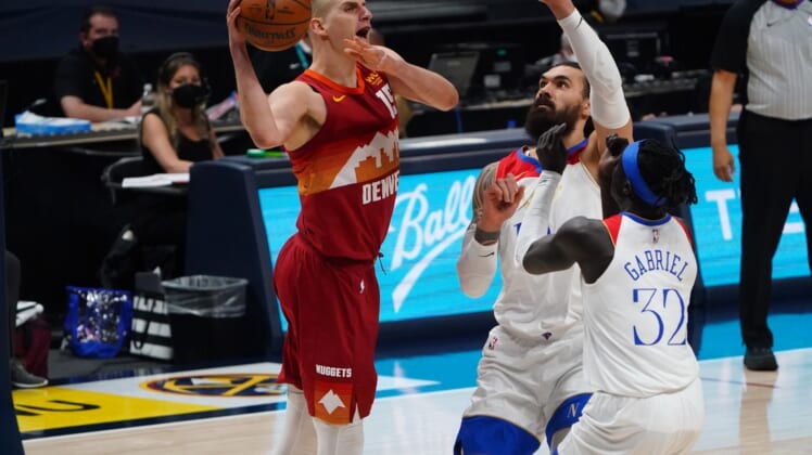 Apr 28, 2021; Denver, Colorado, USA; Denver Nuggets center Nikola Jokic (15) prepares to pass the ball over New Orleans Pelicans center Steven Adams (12) and forward Wenyen Gabriel (32) in the second quarter at Ball Arena. Mandatory Credit: Ron Chenoy-USA TODAY Sports