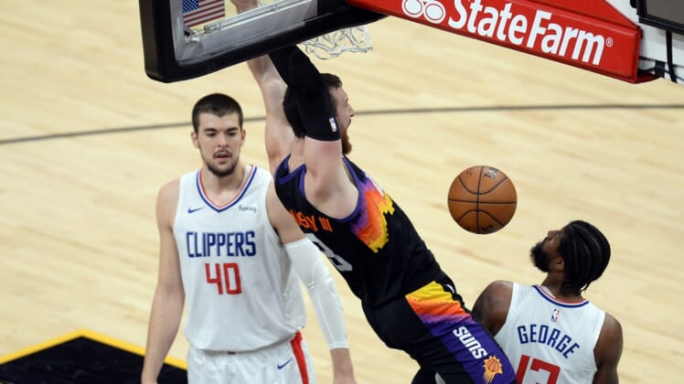 Apr 28, 2021; Phoenix, Arizona, USA; Phoenix Suns forward Frank Kaminsky (8) dunks against LA Clippers center Ivica Zubac (40) and LA Clippers guard Paul George (13) during the first half at Phoenix Suns Arena. Mandatory Credit: Joe Camporeale-USA TODAY Sports