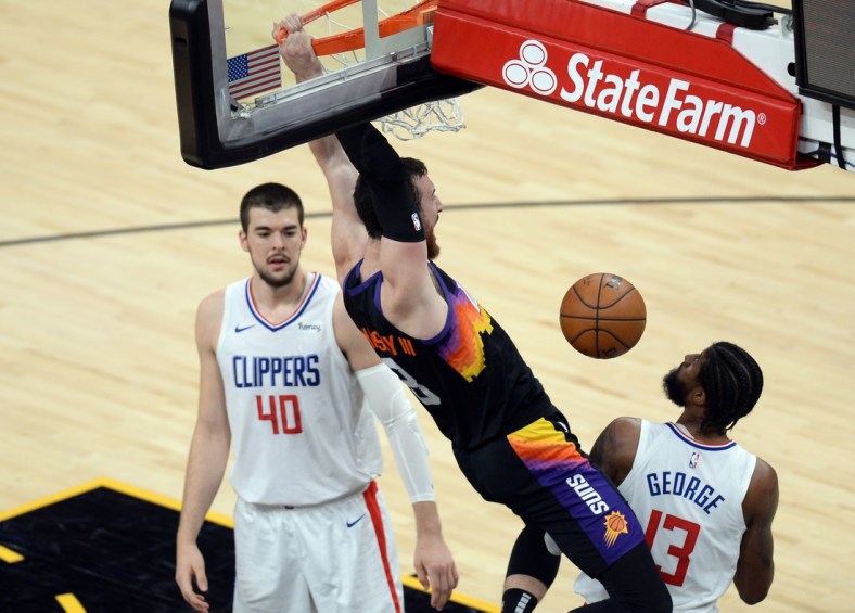 Apr 28, 2021; Phoenix, Arizona, USA; Phoenix Suns forward Frank Kaminsky (8) dunks against LA Clippers center Ivica Zubac (40) and LA Clippers guard Paul George (13) during the first half at Phoenix Suns Arena. Mandatory Credit: Joe Camporeale-USA TODAY Sports