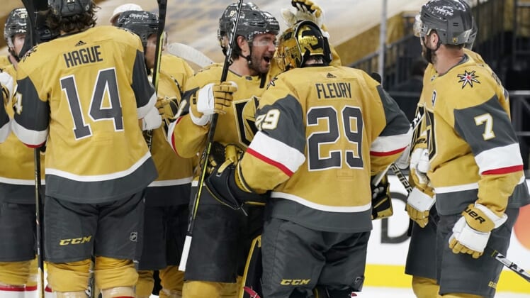 Apr 28, 2021; Las Vegas, Nevada, USA; Vegas Golden Knights defenseman Alec Martinez, center left, celebrates with goaltender Marc-Andre Fleury (29) after defeating the Colorado Avalanche at T-Mobile Arena. Mandatory Credit:  John Locher/POOL PHOTOS-USA TODAY Sports