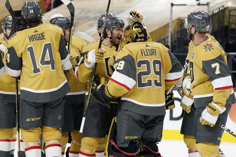 Apr 28, 2021; Las Vegas, Nevada, USA; Vegas Golden Knights defenseman Alec Martinez, center left, celebrates with goaltender Marc-Andre Fleury (29) after defeating the Colorado Avalanche at T-Mobile Arena. Mandatory Credit:  John Locher/POOL PHOTOS-USA TODAY Sports