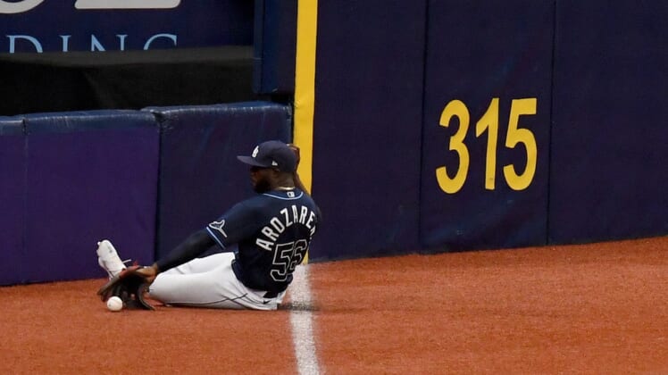 Apr 29, 2021; St. Petersburg, Florida, USA; Tampa Bay Rays outfielder Randy Arozarena (56) slides to field a ground ball in the second  inning against the Oakland Athletics at Tropicana Field. Mandatory Credit: Jonathan Dyer-USA TODAY Sports