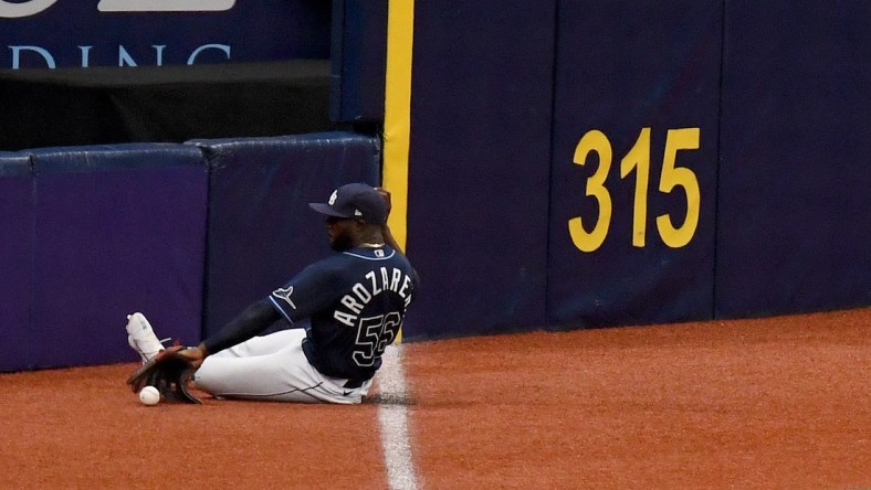 Apr 29, 2021; St. Petersburg, Florida, USA; Tampa Bay Rays outfielder Randy Arozarena (56) slides to field a ground ball in the second  inning against the Oakland Athletics at Tropicana Field. Mandatory Credit: Jonathan Dyer-USA TODAY Sports