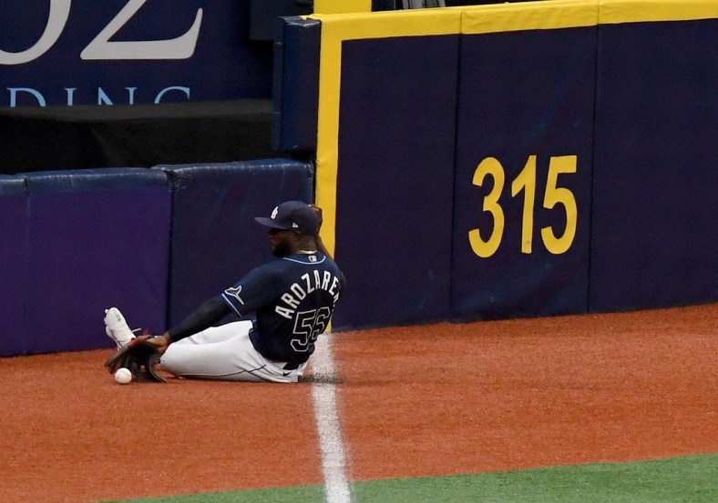 Apr 29, 2021; St. Petersburg, Florida, USA; Tampa Bay Rays outfielder Randy Arozarena (56) slides to field a ground ball in the second  inning against the Oakland Athletics at Tropicana Field. Mandatory Credit: Jonathan Dyer-USA TODAY Sports