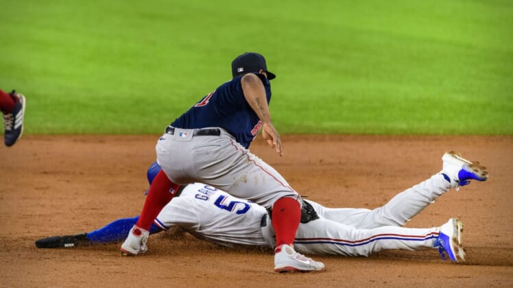 Apr 29, 2021; Arlington, Texas, USA; Boston Red Sox third baseman Rafael Devers (11) tags out Texas Rangers right fielder Adolis Garcia (53) during the second inning at Globe Life Field. Mandatory Credit: Jerome Miron-USA TODAY Sports