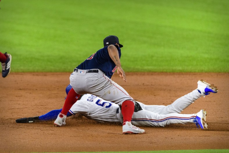Apr 29, 2021; Arlington, Texas, USA; Boston Red Sox third baseman Rafael Devers (11) tags out Texas Rangers right fielder Adolis Garcia (53) during the second inning at Globe Life Field. Mandatory Credit: Jerome Miron-USA TODAY Sports