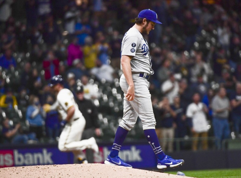 Apr 29, 2021; Milwaukee, Wisconsin, USA;  Los Angeles Dodgers pitcher Trevor Bauer (27) reacts after giving up a two-run home run to Milwaukee Brewers third baseman Travis Shaw (21) in the fourth inning at American Family Field. Mandatory Credit: Benny Sieu-USA TODAY Sports