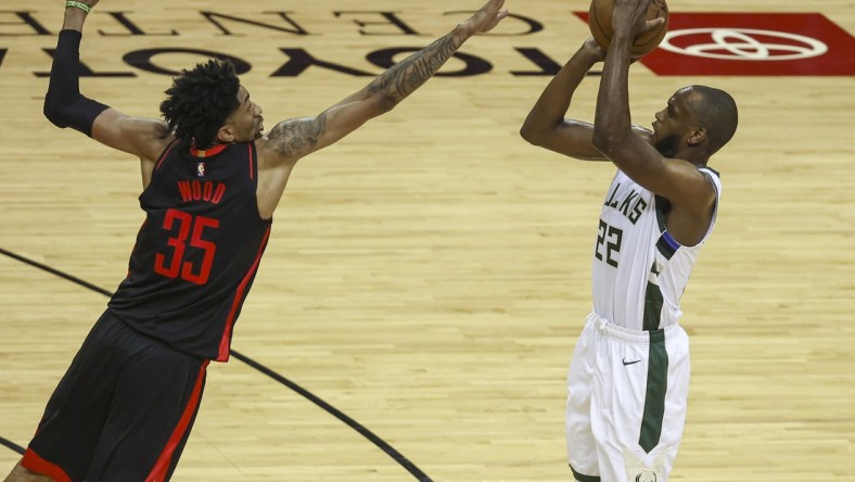 Apr 29, 2021; Houston, Texas, USA; Milwaukee Bucks forward Khris Middleton (22) shoots the ball as Houston Rockets center Christian Wood (35) defends during the third quarter at Toyota Center. Mandatory Credit: Troy Taormina-USA TODAY Sports