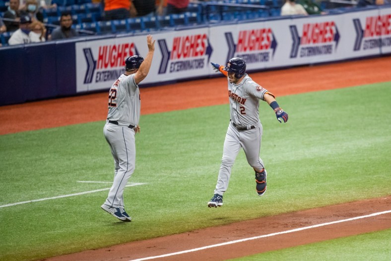 Apr 30, 2021; St. Petersburg, Florida, USA; Houston Astros third baseman Alex Bregman (2) celebrates with third base coach Omar Lopez (22) after hitting a home run during the third inning of a game against the Tampa Bay Rays at Tropicana Field. Mandatory Credit: Mary Holt-USA TODAY Sports