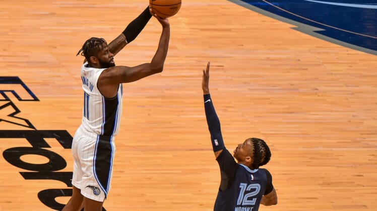 Apr 30, 2021; Memphis, Tennessee, USA; Orlando Magic forward James Ennis III (11) shoots against Memphis Grizzlies guard Ja Morant (12) during the first half at FedExForum. Mandatory Credit: Justin Ford-USA TODAY Sports