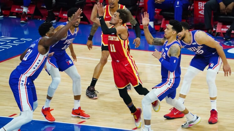 Apr 30, 2021; Philadelphia, Pennsylvania, USA; Atlanta Hawks guard Trae Young (11) goes up for a shot as forward John Collins (behind 11) looks on and Philadelphia 76ers center Joel Embiid (21), forward Tobias Harris (12), forward Danny Green (second from right) and guard Ben Simmons (25) defend in the third quarter at Wells Fargo Center. Mandatory Credit: James Lang-USA TODAY Sports