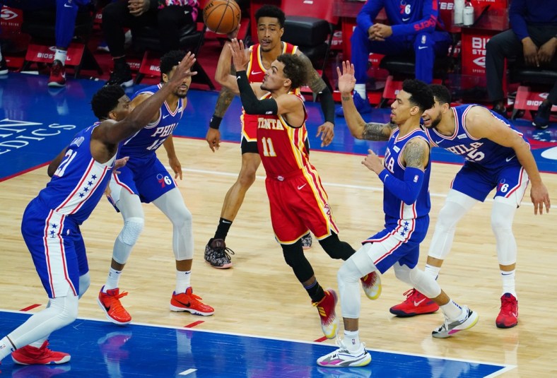 Apr 30, 2021; Philadelphia, Pennsylvania, USA; Atlanta Hawks guard Trae Young (11) goes up for a shot as forward John Collins (behind 11) looks on and Philadelphia 76ers center Joel Embiid (21), forward Tobias Harris (12), forward Danny Green (second from right) and guard Ben Simmons (25) defend in the third quarter at Wells Fargo Center. Mandatory Credit: James Lang-USA TODAY Sports