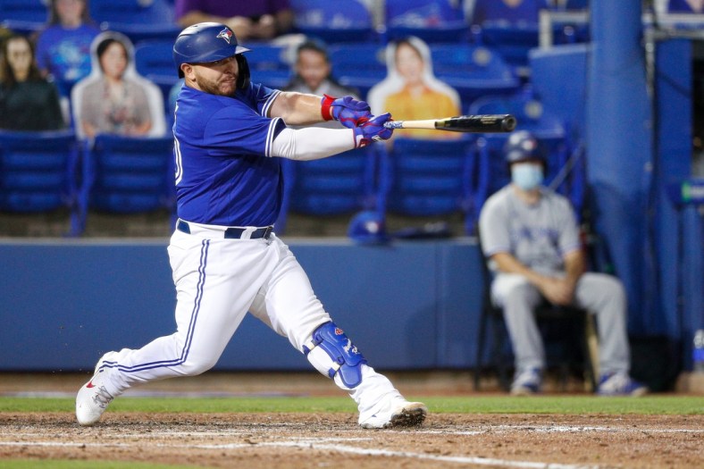 Apr 30, 2021; Dunedin, Florida, CAN;  Toronto Blue Jays catcher Alejandro Kirk (30) hits a two-run home run in the fourth inning against the Atlanta Braves at TD Ballpark. Mandatory Credit: Nathan Ray Seebeck-USA TODAY Sports