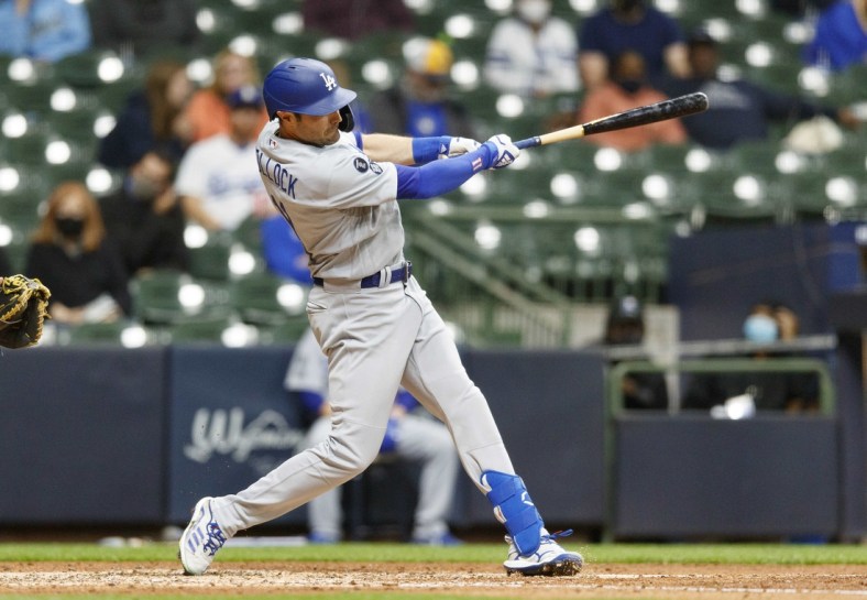 Apr 30, 2021; Milwaukee, Wisconsin, USA;  Los Angeles Dodgers left fielder AJ Pollock (11) hits a solo home run during the fifth inning against the Milwaukee Brewers at American Family Field. Mandatory Credit: Jeff Hanisch-USA TODAY Sports