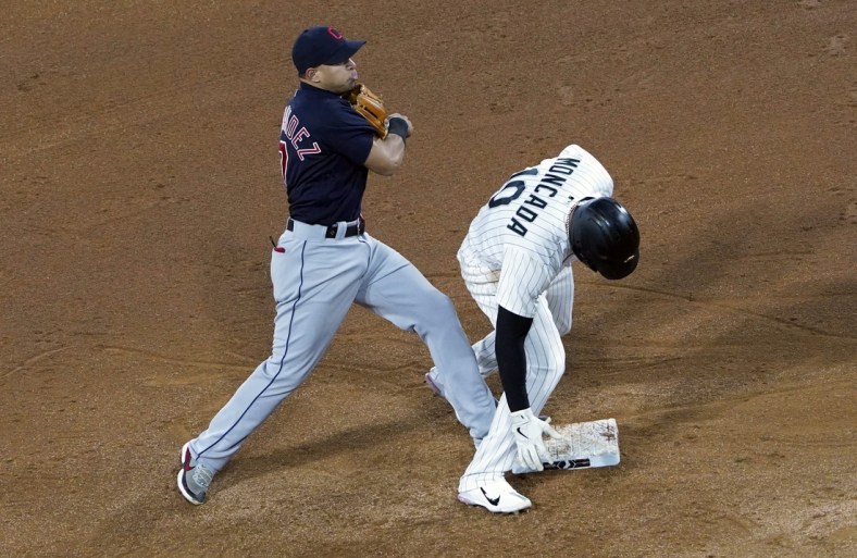 Apr 30, 2021; Chicago, Illinois, USA; Cleveland Indians shortstop Andres Gimenez (0) forces out Chicago White Sox third baseman Yoan Moncada (10) at second base during the fifth inning at Guaranteed Rate Field. Mandatory Credit: David Banks-USA TODAY Sports