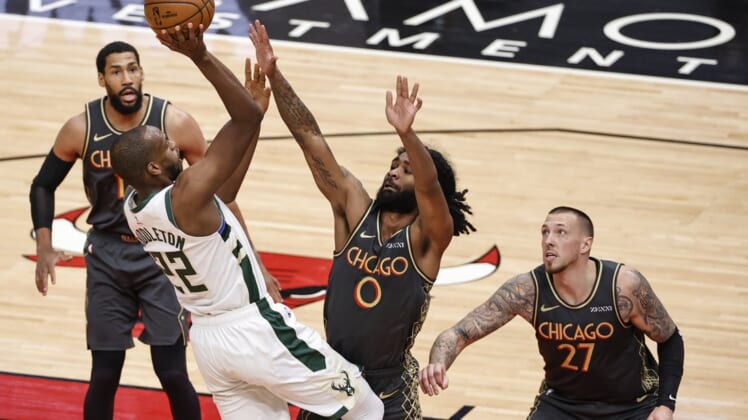 Apr 30, 2021; Chicago, Illinois, USA; Milwaukee Bucks forward Khris Middleton (22) shoots against Chicago Bulls guard Coby White (0) during the first half of an NBA basketball game at United Center. Mandatory Credit: Kamil Krzaczynski-USA TODAY Sports