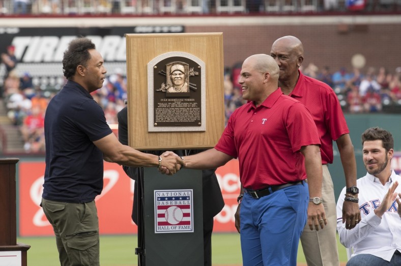 Aug 12, 2017; Arlington, TX, USA; Baseball Hall of Fame members Hall of Fame members Roberto Alomar and Fergie Jenkins unveil Ivan Rodriguez's plaque before the game between the Texas Rangers and the Houston Astros at Globe Life Park in Arlington. Mandatory Credit: Jerome Miron-USA TODAY Sports