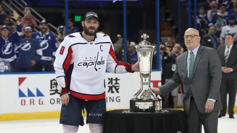 May 23, 2018; Tampa, FL, USA; Washington Capitals left wing Alex Ovechkin (8) is presented with the Prince of Wales Trophy from NHL deputy commissioner Bill Daly after defeating the Tampa Bay Lightning in game seven of the Eastern Conference Final in the 2018 Stanley Cup Playoffs at Amalie Arena. Mandatory Credit: Kim Klement-USA TODAY Sports