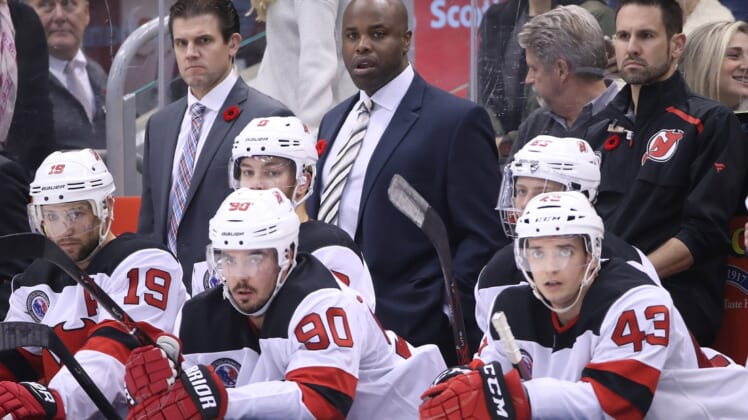 Nov 9, 2018; Toronto, Ontario, CAN; New Jersey Devils assistant coaches Rick Kowalsky and Mike Grier look on from behind the bench as center Travis Zajac (19) and left wing Taylor Hall (9) and left wing Marcus Johansson (90) watch the action against the Toronto Maple Leafs at Scotiabank Arena. The Maple Leafs beat the Devils 6-1. Mandatory Credit: Tom Szczerbowski-USA TODAY Sports
