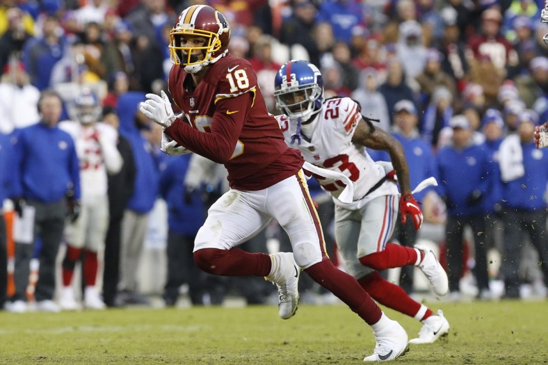 Dec 9, 2018; Landover, MD, USA; Washington Redskins wide receiver Josh Doctson (18) runs with the ball past New York Giants cornerback B.W. Webb (23) in the fourth quarter at FedEx Field. The Giants won 40-16. Mandatory Credit: Geoff Burke-USA TODAY Sports