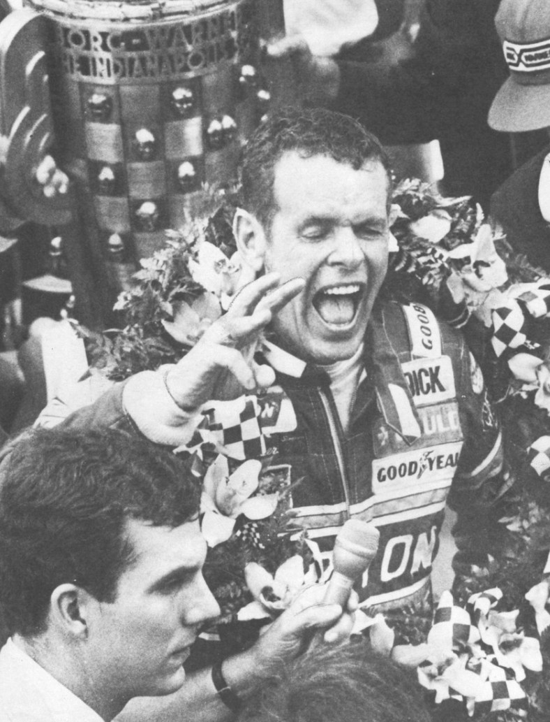 Bobby Unser shouts for joy in Victory Lane with the wreath of orchids around his shoulders and the Borg-Warner trophy behind him on May 24, 1981.

Unser