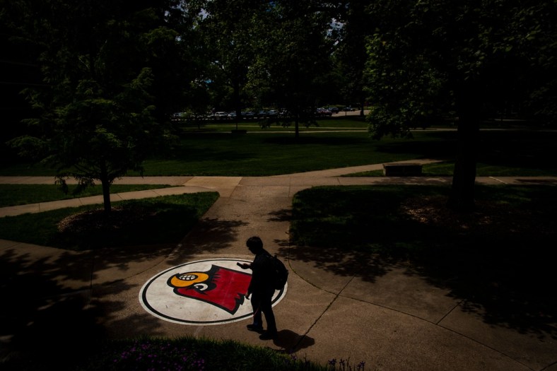 A student looks at his phone as he walks past a cardinal logo Tuesday on the University of Louisville campus. May 14, 2019

T9i1125 Uofl Campus