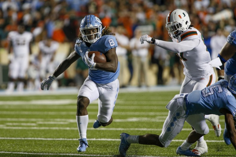 Sep 7, 2019; Chapel Hill, NC, USA; North Carolina Tar Heels running back Michael Carter (8) rushes for a first down against the Miami Hurricanes during a game-winning drive in the fourth quarter at Kenan Memorial Stadium. The North Carolina Tar Heels won 28-25. Mandatory Credit: Nell Redmond-USA TODAY Sports