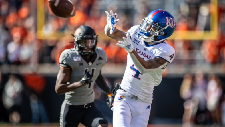 Nov 16, 2019; Stillwater, OK, USA; Kansas Jayhawks wide receiver Andrew Parchment (4) makes a catch while defended by Oklahoma State Cowboys cornerback A.J. Green (4) during the first half at Boone Pickens Stadium. Mandatory Credit: Rob Ferguson-USA TODAY Sports