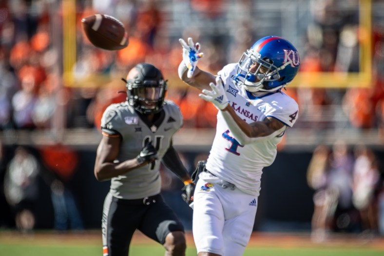Nov 16, 2019; Stillwater, OK, USA; Kansas Jayhawks wide receiver Andrew Parchment (4) makes a catch while defended by Oklahoma State Cowboys cornerback A.J. Green (4) during the first half at Boone Pickens Stadium. Mandatory Credit: Rob Ferguson-USA TODAY Sports