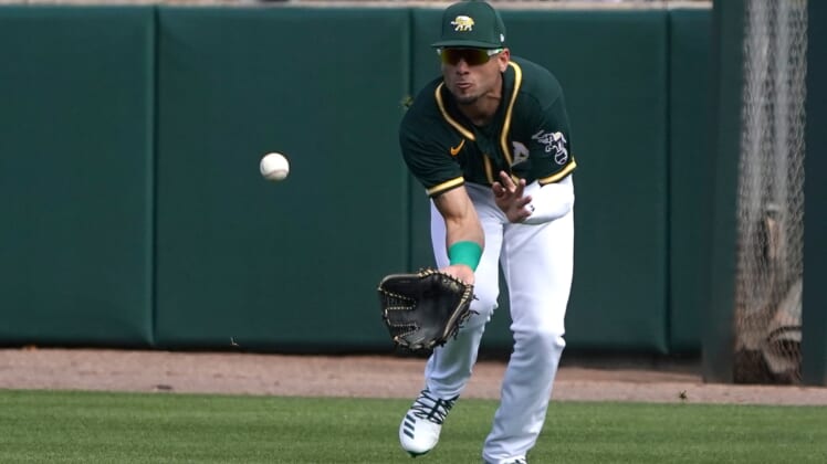 Feb 23, 2020; Mesa, Arizona, USA; Oakland Athletics right fielder Luis Barrera (79) makes the running catch for an out against the San Francisco Giants during a spring training game at HohoKam Stadium. Mandatory Credit: Rick Scuteri-USA TODAY Sports