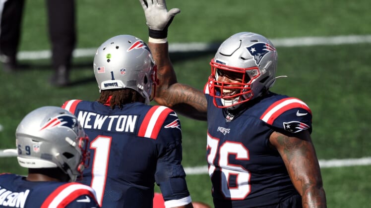 Sep 13, 2020; Foxborough, Massachusetts, USA; New England Patriots quarterback Cam Newton (1) celebrates with offensive tackle Isaiah Wynn (76) after scoring a touchdown against the Miami Dolphins during the third quarter at Gillette Stadium. Mandatory Credit: Brian Fluharty-USA TODAY Sports