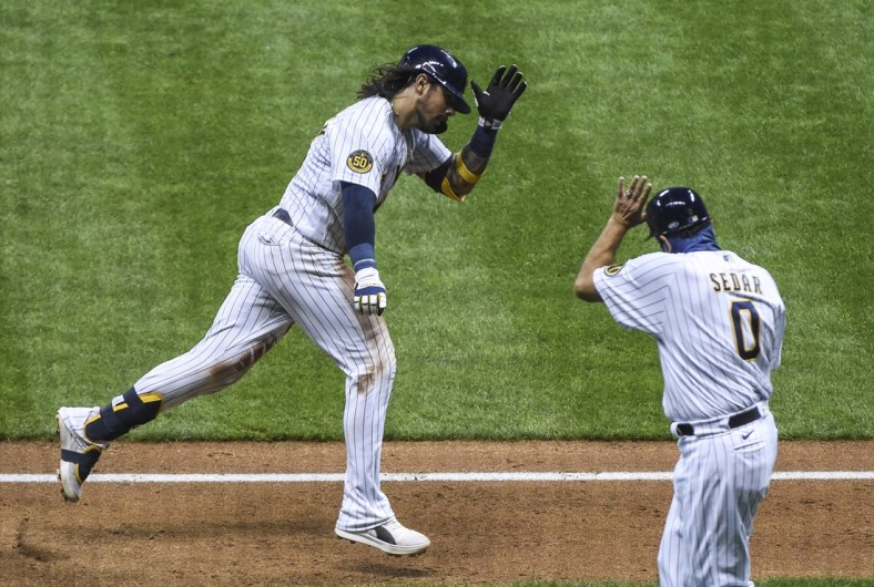 Sep 16, 2020; Milwaukee, Wisconsin, USA; Milwaukee Brewers catcher Jacob Nottingham (26) reacts with third base coach Ed Sedar after hitting a 2-run homer in the sixth inning against the St. Louis Cardinals at Miller Park. Mandatory Credit: Benny Sieu-USA TODAY Sports