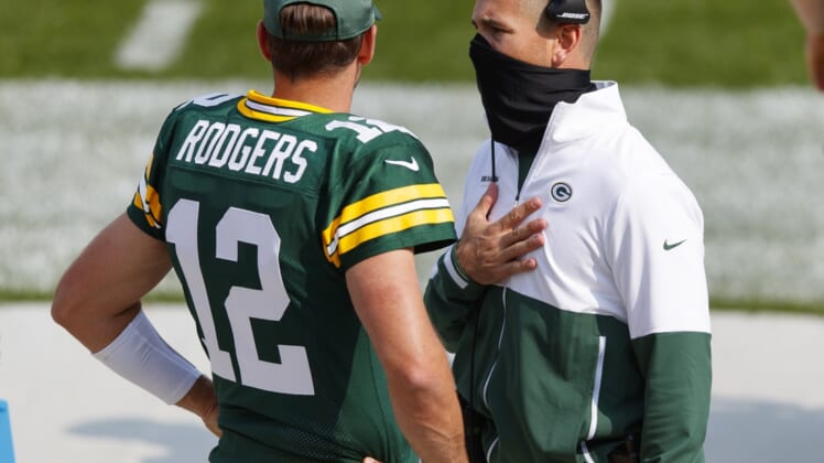 Sep 20, 2020; Green Bay, Wisconsin, USA;  Green Bay Packers quarterback Aaron Rodgers (12) talks with head coach Matt LaFleur during the third quarter of the game against the Detroit Lions at Lambeau Field. Mandatory Credit: Jeff Hanisch-USA TODAY Sports